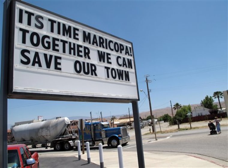 In this photo taken June 13, 2011, a sign is seen outside of the Shell gas station in Maricopa, Calif. Its own county grand jury has recommended that this tiny San Joaquin Valley community be dissolved because It's too poor to be a town anymore. 